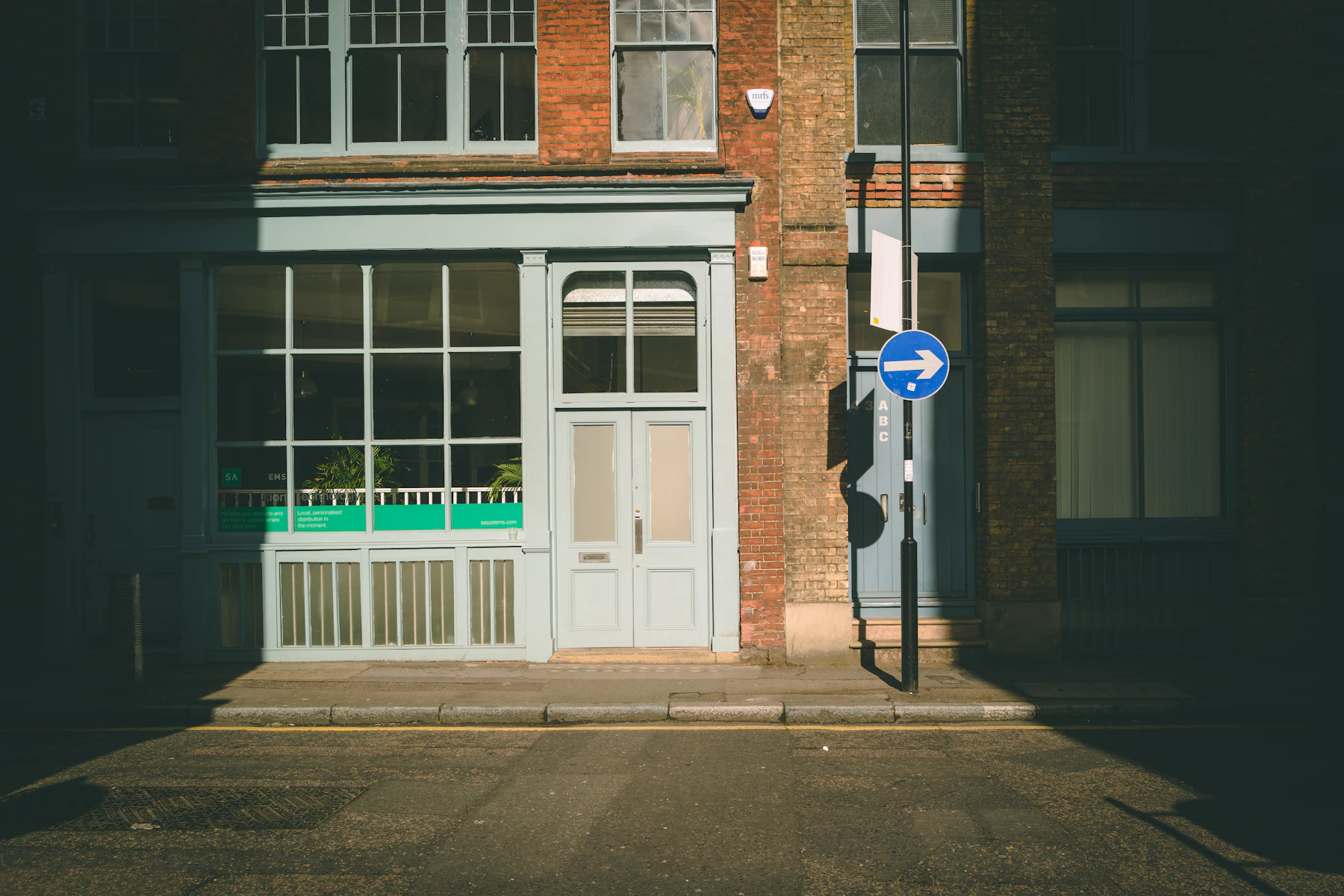 Early morning sunlight on brick buildings along an East London street