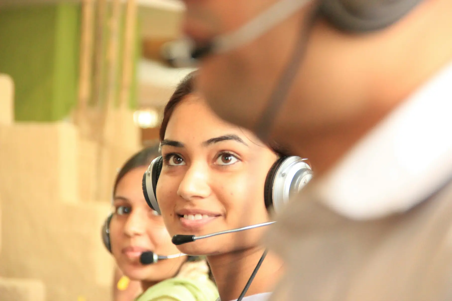 Home Customer service representatives wearing headsets in an office