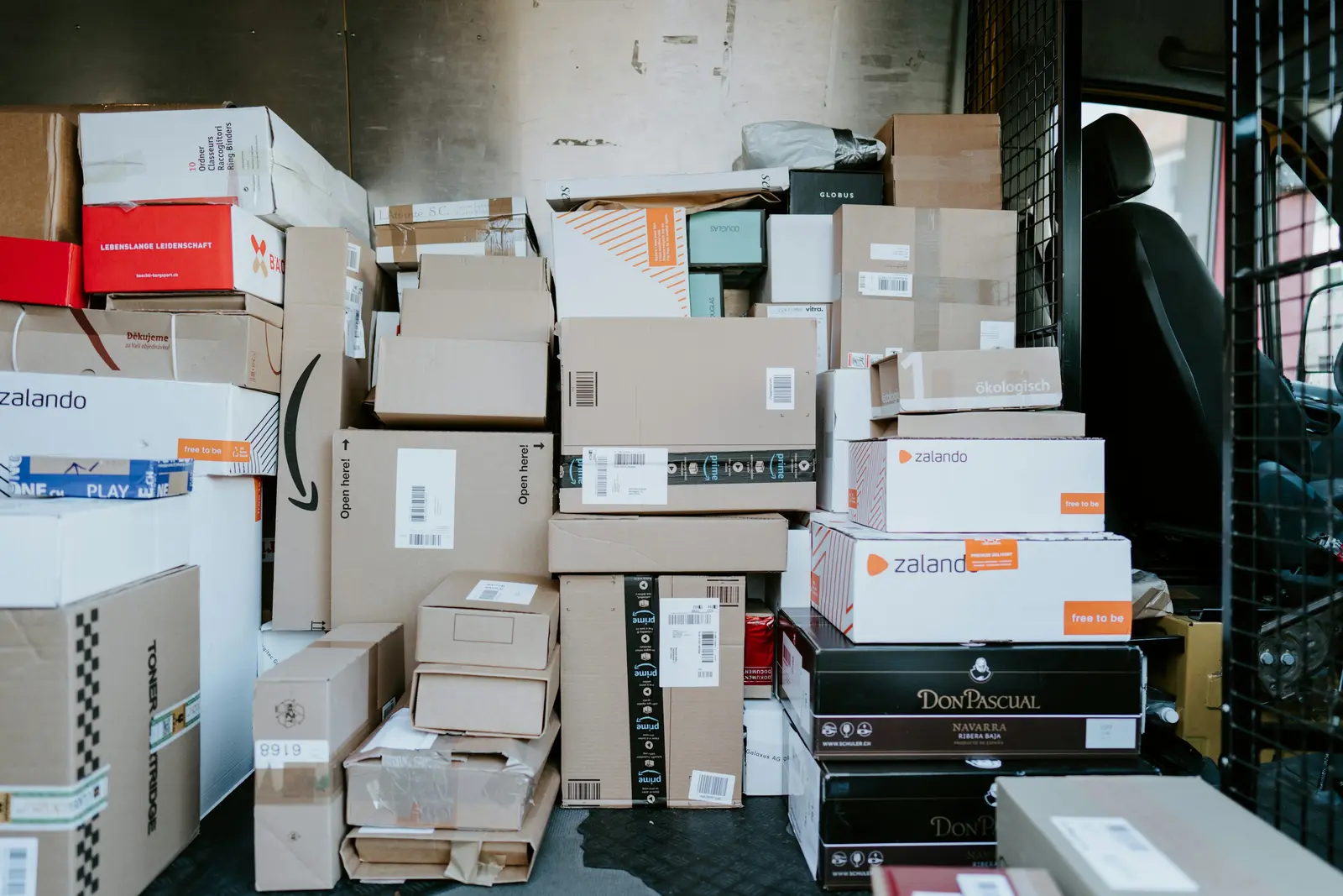 Home Cardboard parcels stacked inside a delivery van