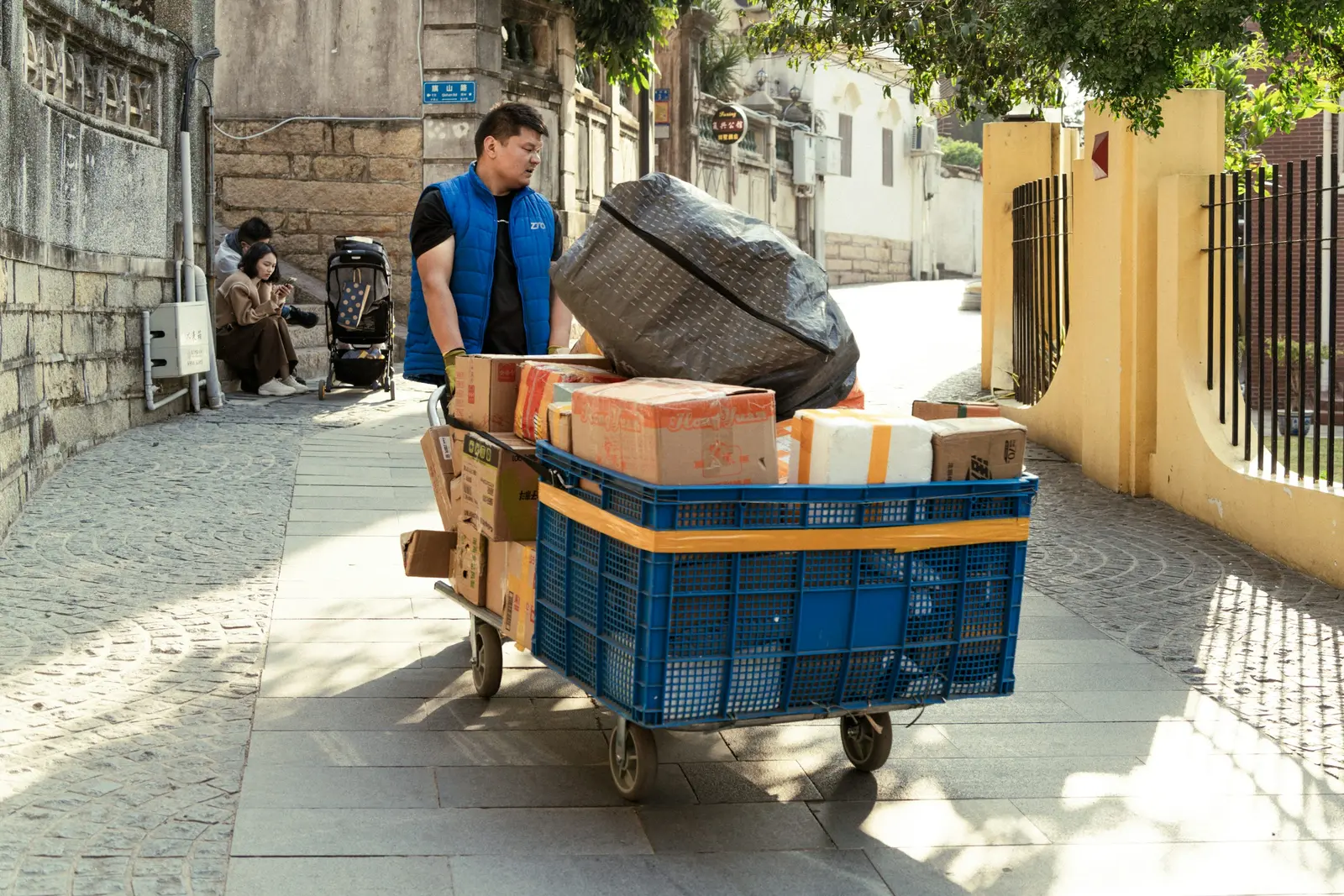 Home Delivery worker transporting parcels on a cart