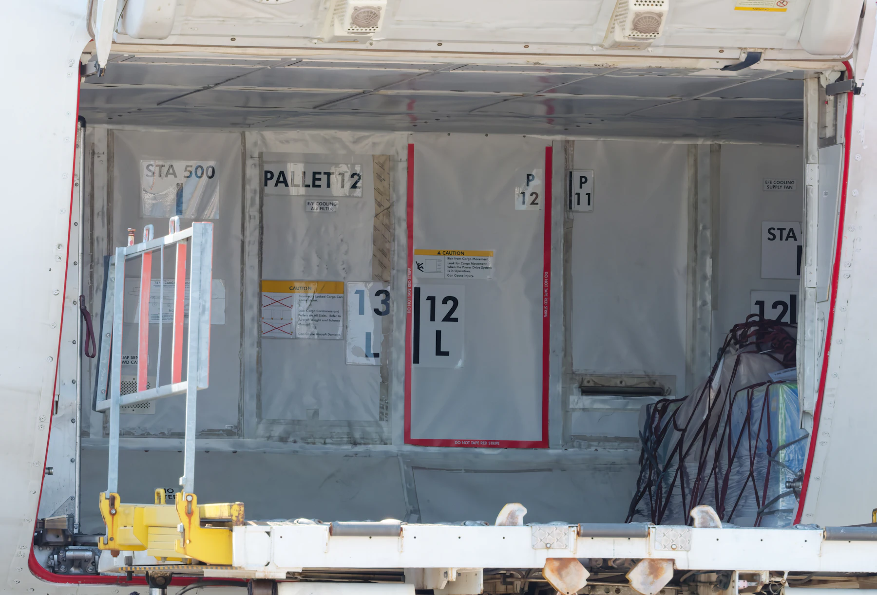Cargo containers being loaded into the hold of an aircraft