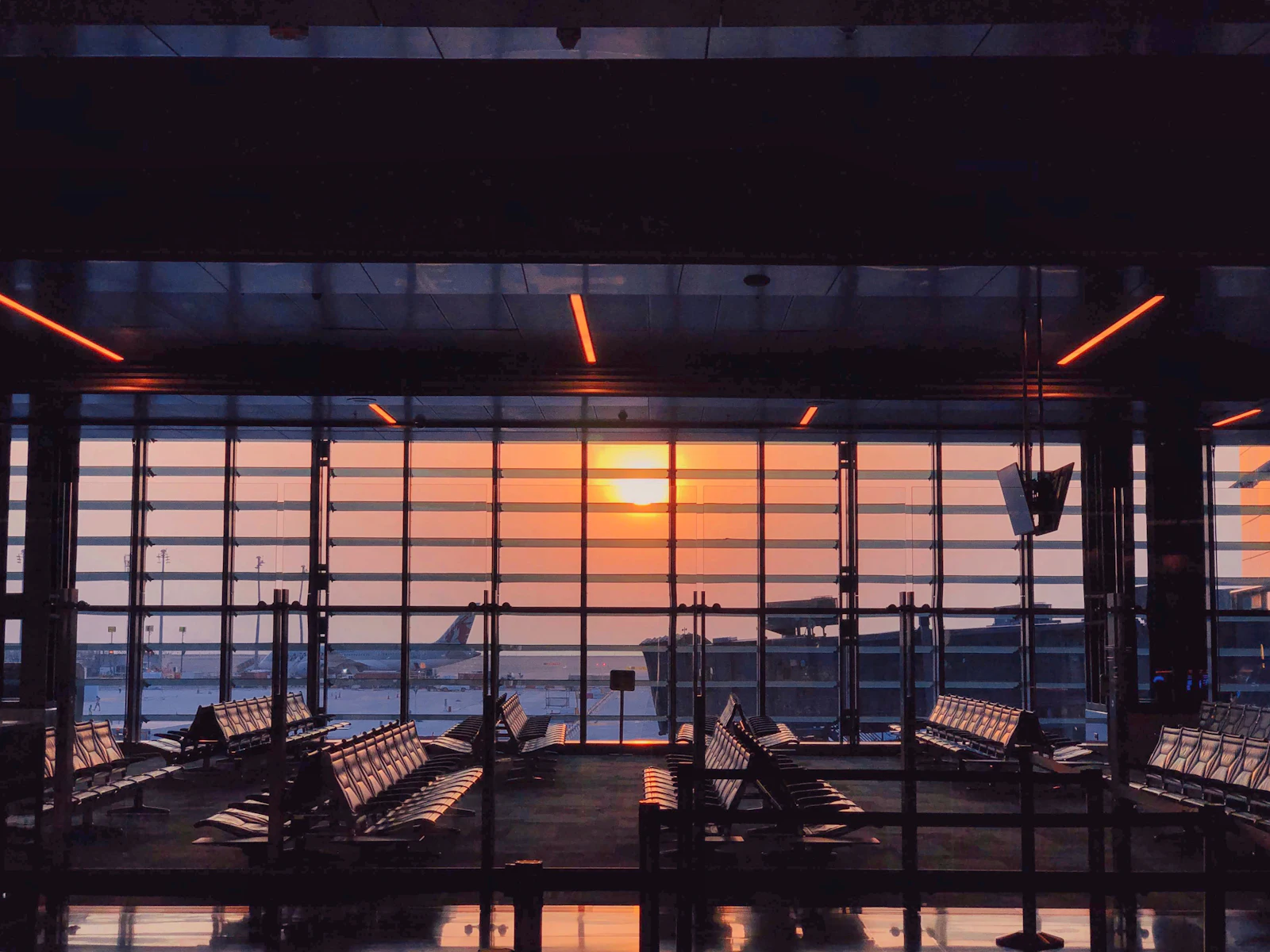International Repatriation Low sun through a quiet airport terminal window looking out over the apron