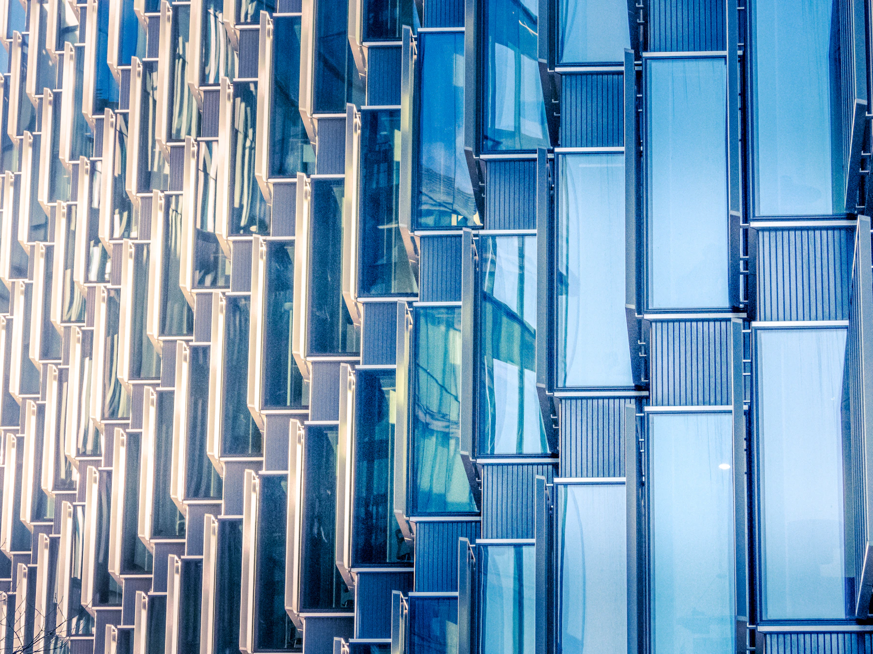 Privacy policy Grid of blue window frames on a modern building facade